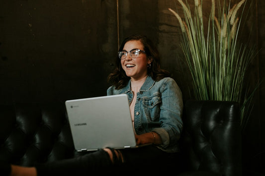 Woman working on a silver laptop