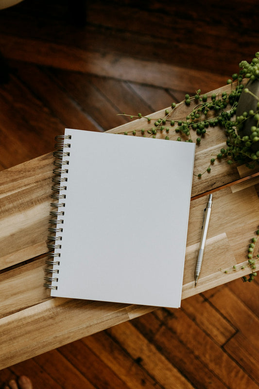 Notebook and pen on a wooden table