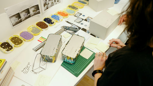 Designer working on a project at a table with color samples